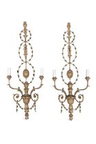 A PAIR OF CARVED GILTWOOD AND GESSO TWO BRANCH WALL SCONCES, c. 1900, of classical design with