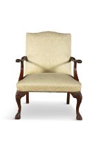 A GEORGIAN STYLE MAHOGANY AND UPHOLSTERED OPEN ARMCHAIR, covered in a yellow floral damask,