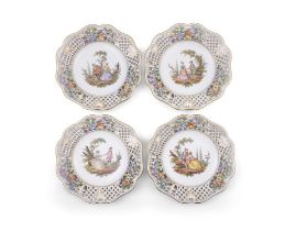 A SET OF FOUR MEISSEN STYLE PORCELAIN PLATES each with pierced borders, the centre reserve