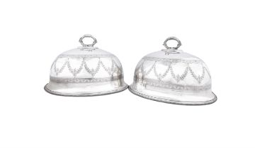 A PAIR OF VICTORIAN EPNS MEAT DISH COVERS, of domed oval form with handles, 36cm wide