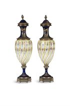 A PAIR OF FRENCH SPIRAL MOULDED PORCELAIN URNS, 19TH CENTURY of elegant baluster shape,