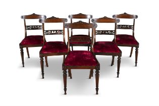 A SET OF SIX REGENCY ROSEWOOD FRAMED DINING CHAIRS, each with curved tablet back above a curved