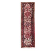 AN OLD IRANIAN RUNNER, 275 x 82cm the central field woven with three diamond lozenges,