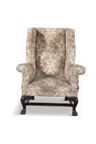 A GEORGE III STYLE MAHOGANY FRAMED AND UPHOLSTERED WINGBACK ARMCHAIR, 19TH CENTURY on acanthus