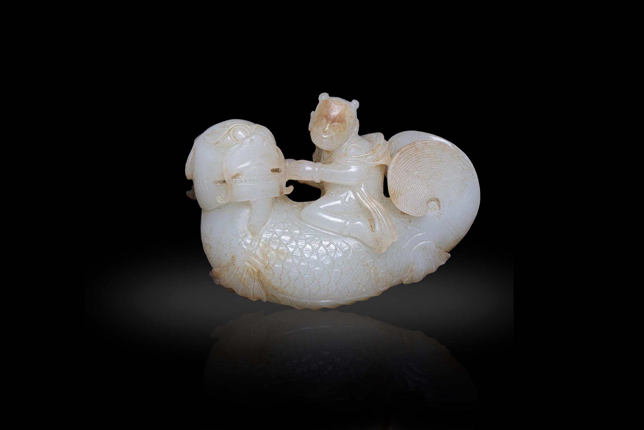 A WHITE JADE AND RUSSET 'BOY RIDING THE DRAGON-FISH' GROUP 明代 白玉獨佔鰲頭 China,