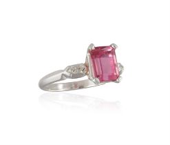 A TOURMALINE AND DIAMOND RING, composed of a rectangular-cut pink tourmaline weighing approximately