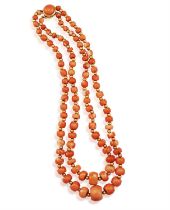 λ A GOLD AND CORAL BEAD NECKLACE, composed of two graduated strands, set with graduated coral beads