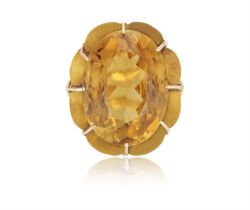 A RETRO CITRINE COCKTAIL RING, CIRCA 1950, set with an oval-shaped citrine, within a raised