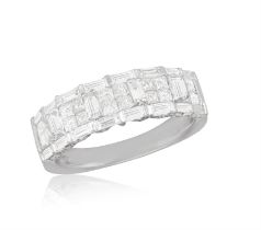 A DIAMOND RING, set to the front with square-cut and baguette diamond in a geometric pattern,