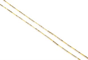 A GOLD NECKLACE, CIRCA 1860, the long-chain composed of hexagonal barrel motifs with floral scroll