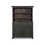 A GREEN PAINTED PINE DRESSER, the moulded cornice above two open shelves and plain slated back,