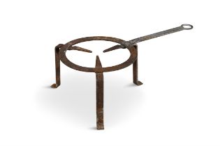 A CIRCULAR WROUGHT IRON TRIVET with tripod supports. 17.5cm high, 53cm wide, 25cm diameter