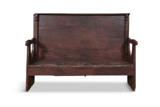 A 19TH CENTURY PAINTED SETTLE BENCH, the high panel back with carved shaped supports above a