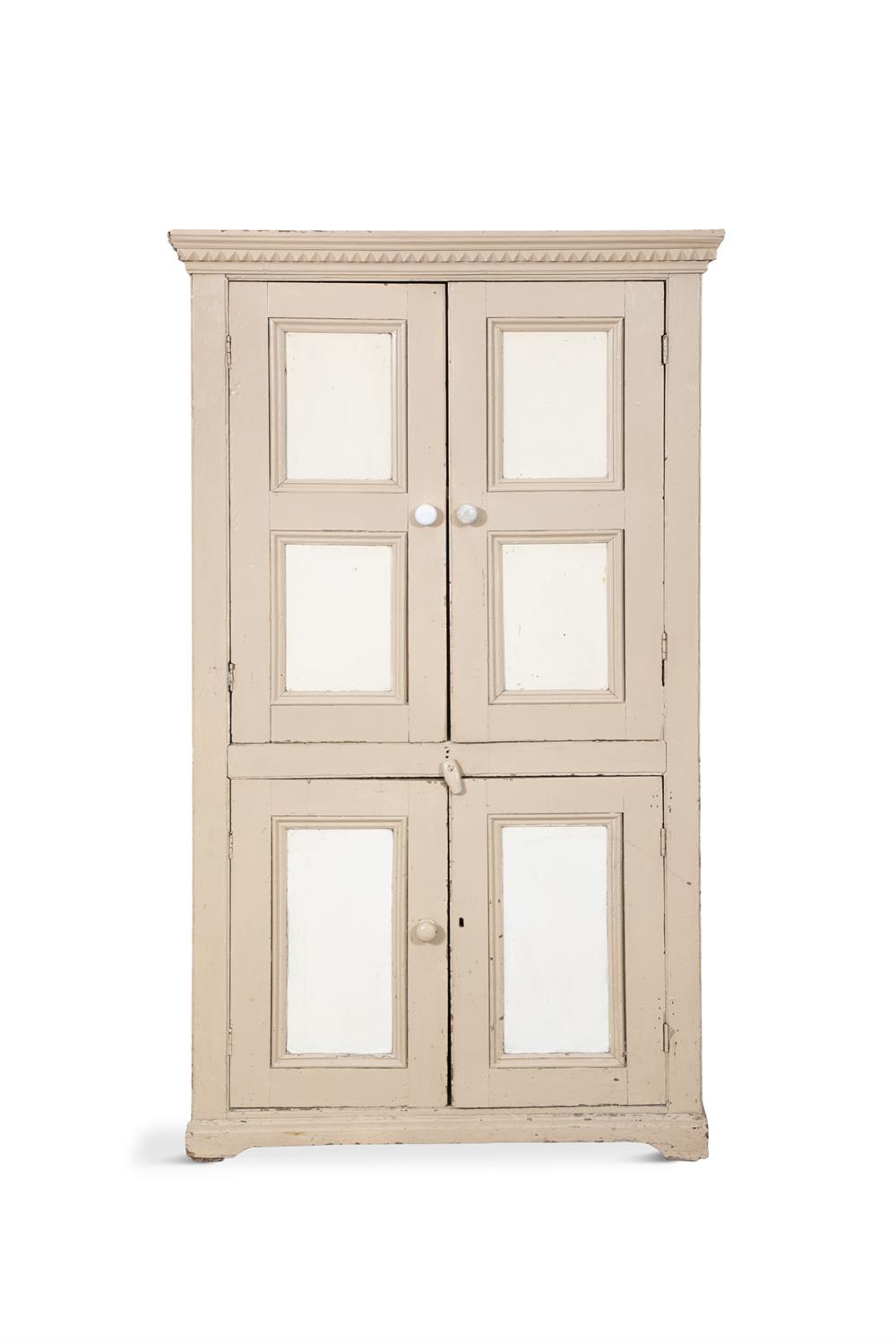 A 19TH CENTURY PAINTED PINE CUPBOARD, the cornice with saw-tooth dentil moulding above two twin