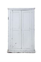 A PAINTED PINE CUPBOARD, the moulded top and two long panel doors with fitted interior raised on