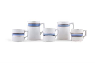 TWO CARRIGALINE WHITE GLAZED EARTHENWARE JUGS blue within brown. 14cm; together with three