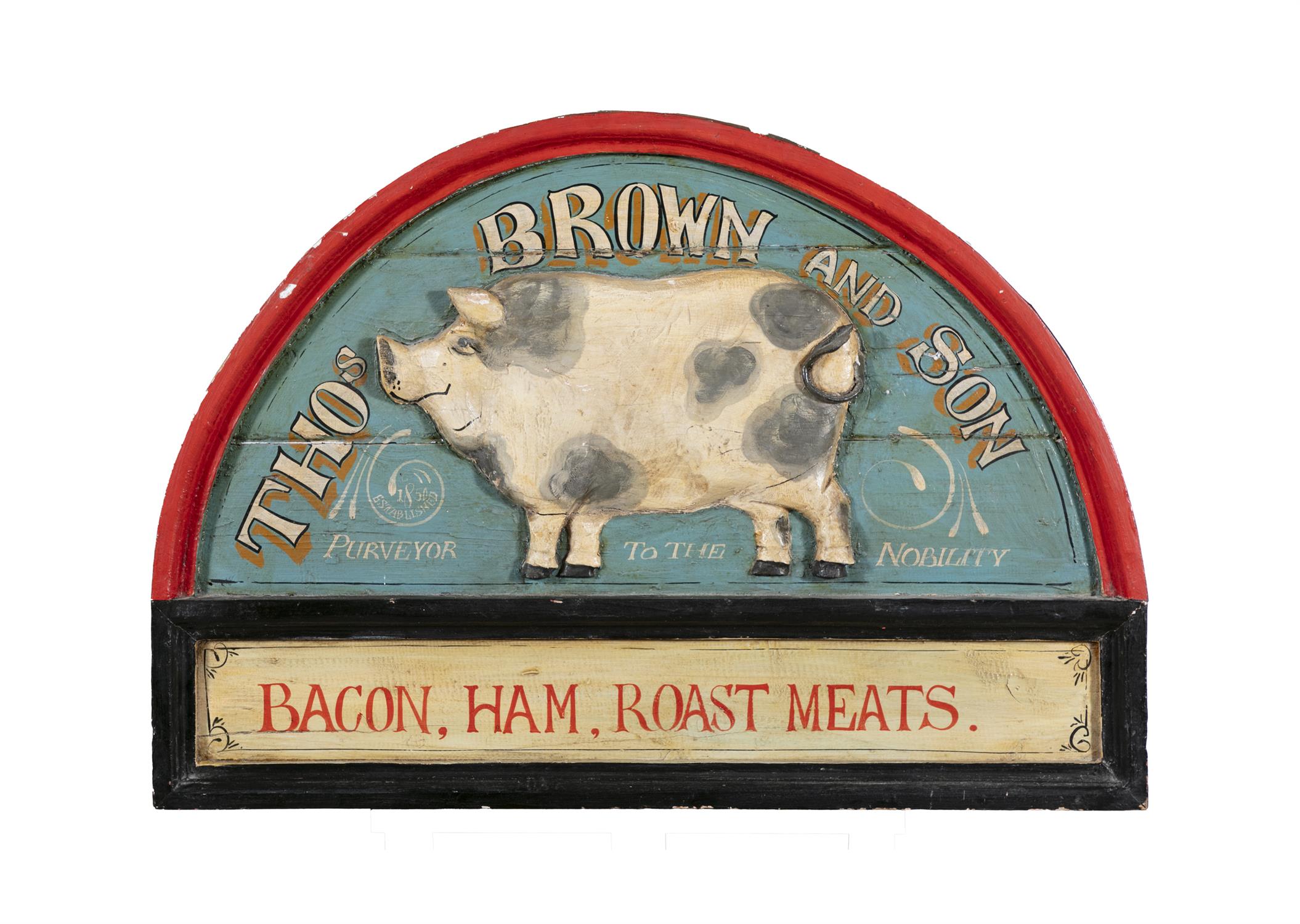 A PAINTED TIMBER SHOP SIGN, arch top with relief pig and inscribed 'Thomas Brown & Son,
