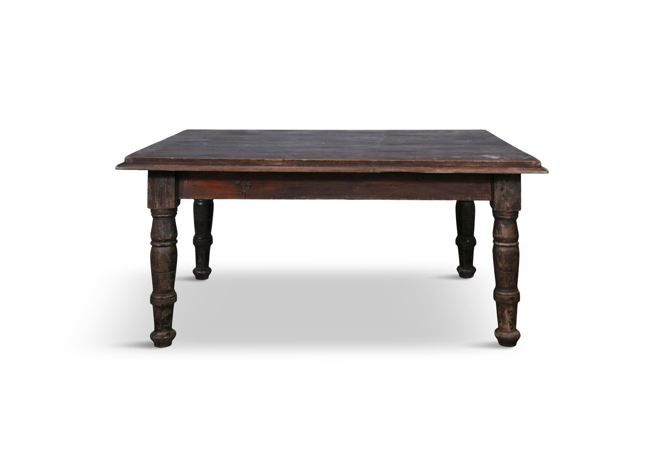 A 19TH CENTURY STAINED KITCHEN TABLE, the seven panel top with moulded rim above a plain frieze