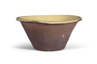 A LARGE POTTERY BOWL, of tapered circular form, with out-turned rim, the bowl with yellow enamel.