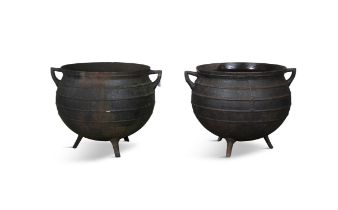 A MATCHED PAIR OF BLACK METAL CALDRONS, each of circular form with moulded rim,