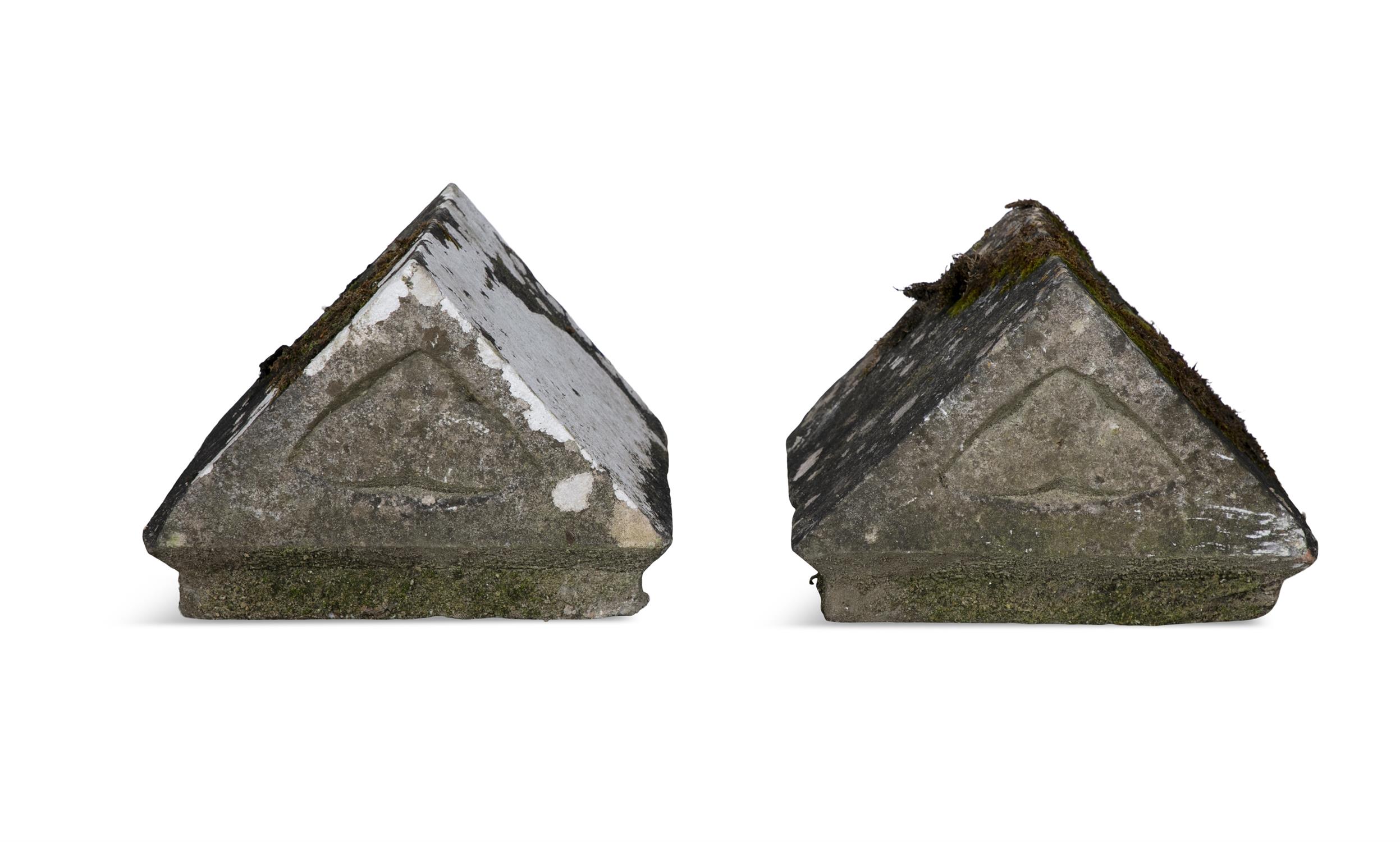 A PAIR OF EARLY 19TH CENTURY IRISH LIMESTONE PILAR CARS, of triangular form with carved
