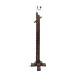 A IRON AND TIMBER ADJUSTABLE RUSH LIGHT, on X-framed base. 120.5cm high (not extended)