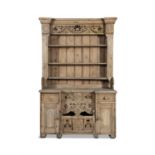AN IRISH STRIPPED PINE KITCHEN DRESSER, the carved and pierced frieze above open shelves on a