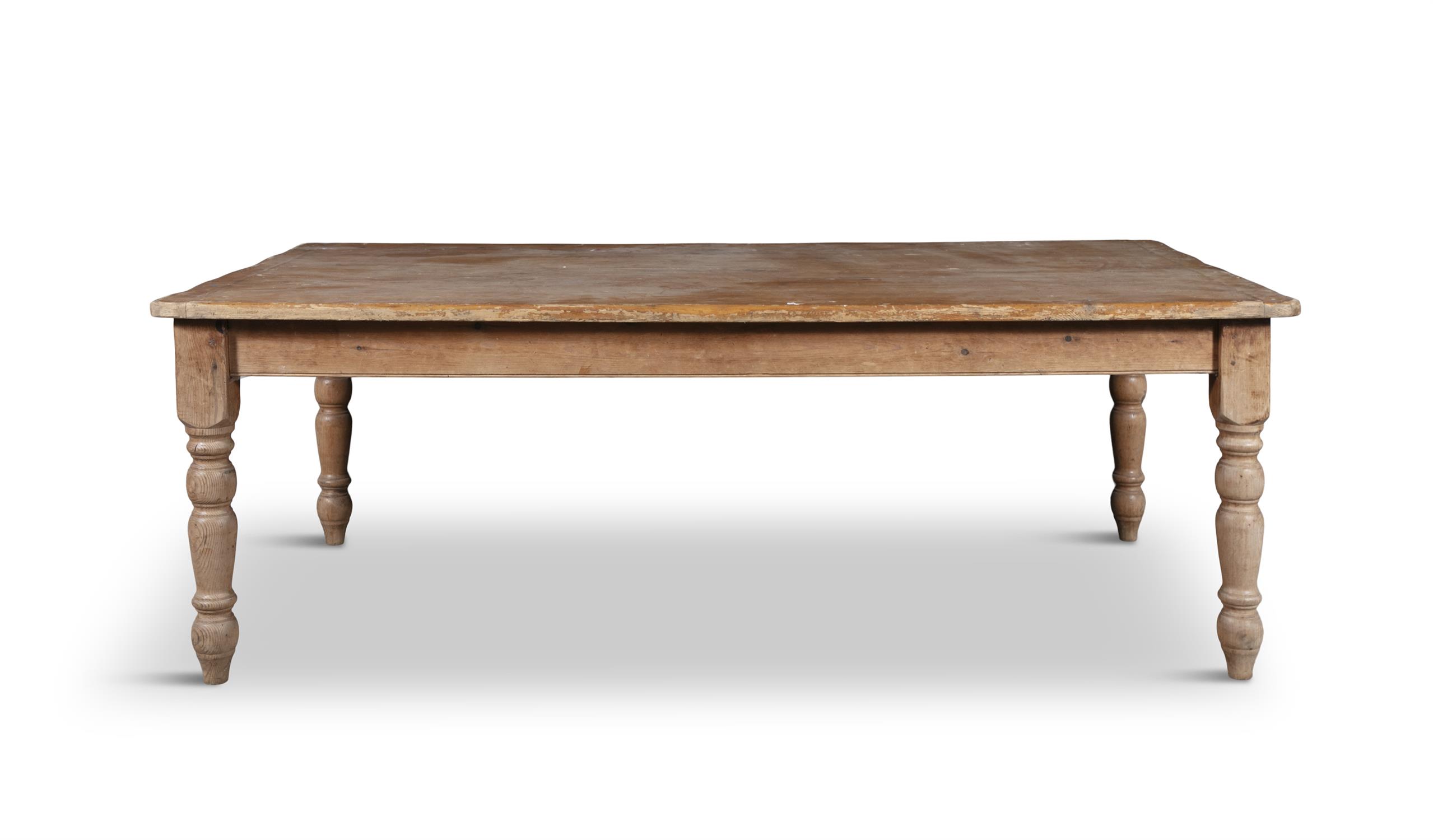 A LARGE PINE RECTANGULAR FARMHOUSE TABLE, LATE 19TH CENTURY, on turned tapering legs.