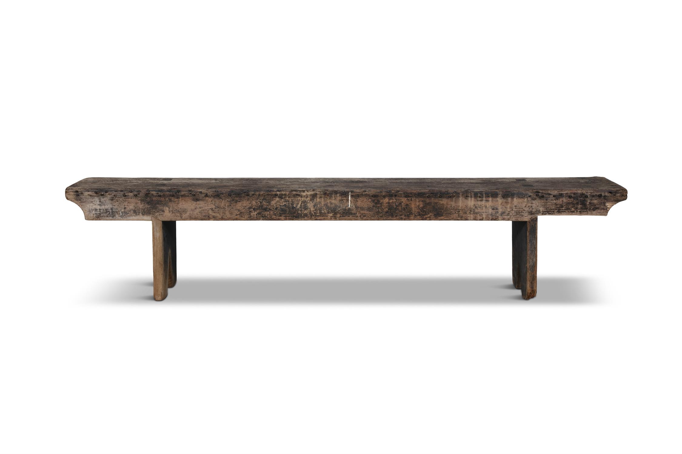 A 19TH CENTURY STAINED LONG BENCH, with plain seat above a shaped frieze with trestle feet.