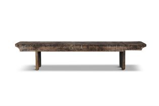 A 19TH CENTURY STAINED LONG BENCH, with plain seat above a shaped frieze with trestle feet.