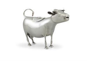 A WHITE METAL COW CREAMER makers mark 'MG', other marks rubbed, modelled standing,