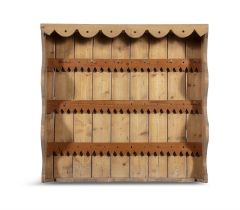 A STRIPPED PINE OPEN HANGING WALL RACK WITH DECORATIVE FRIEZE, 94cm high, 100cm wide, 21cm deep.