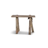 A PLAIN MILKING STOOL with four spindle supports. 34cm high, 40cm wide Provenance: Mountrath,