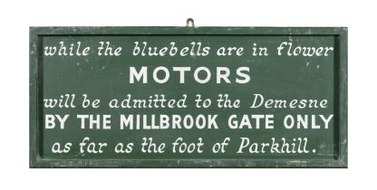 A GREEN AND WHITE PAINTED TIMBER ESTATE SIGN 'WHILE THE BLUEBELLS ARE IN FLOWER MOTORS WILL BE