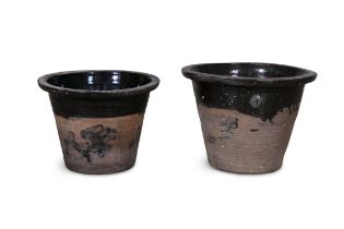 TWO TERRACOTTA MILK CROCKS, the moulded rim with glazed interior and body. 28cm and 30cm high