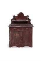 A 19TH CENTURY RED PAINTED TIMBER SCALE MODEL OF AN IRISH CUPBOARD, the wavy gallery back with