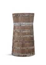 AN OAK AND METAL BOUND BUTTER CHURN, of coopered construction. 89cm high