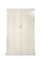 A WHITE PAINTED CUPBOARD, moulded top above five coffered panel doors enclosing a fitted