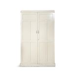 A WHITE PAINTED CUPBOARD, moulded top above five coffered panel doors enclosing a fitted