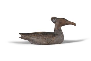 A BROWN PAINTED AND CARVED WOODEN DUCK DECOY with crown top. 16cm high, 34cm long, 13cm wide,