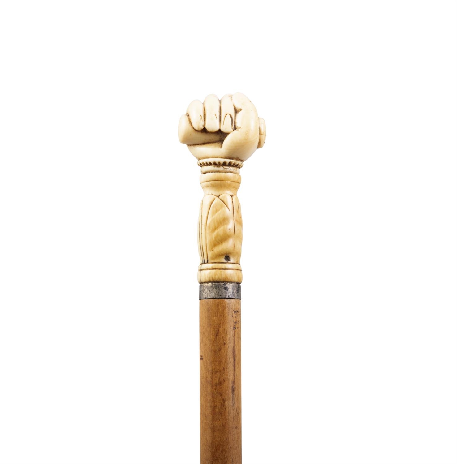 *A WOODEN WALKING CANE, with carved ivory handle in the shape of a fist enclosing a seal, - Image 2 of 2