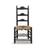 A BLACK PAINTED SHAKER CHAIR, PHILADELPHIA, LATE 18TH CENTURY the humped ladder back flanked by