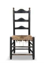 A BLACK PAINTED SHAKER CHAIR, PHILADELPHIA, LATE 18TH CENTURY the humped ladder back flanked by