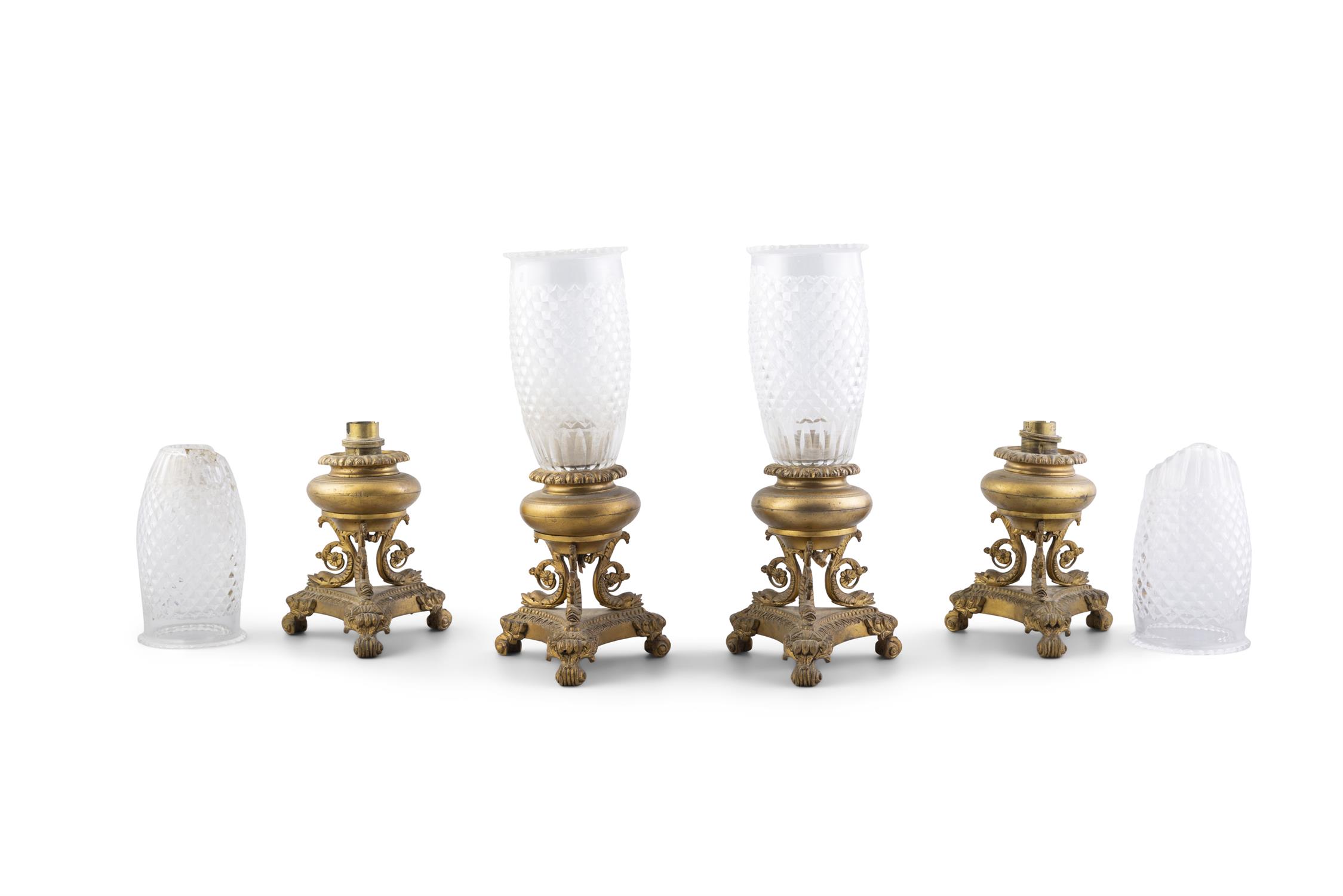 A SET OF FOUR ORMOLU LAMP BASES, 19TH CENTURY, on triple scroll dolphin supports,