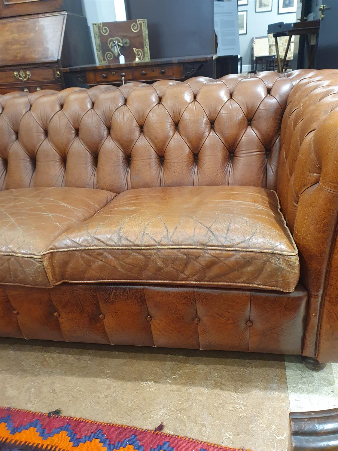 A CHESTERFIELD BUTTON BACK THREE SEATER SOFA, upholstered in brown leather with scroll-end - Image 11 of 18