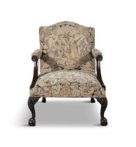 A GEORGE III MAHOGANY FRAMED GAINSBOROUGH ARMCHAIR the arched padded back and seat covered in a