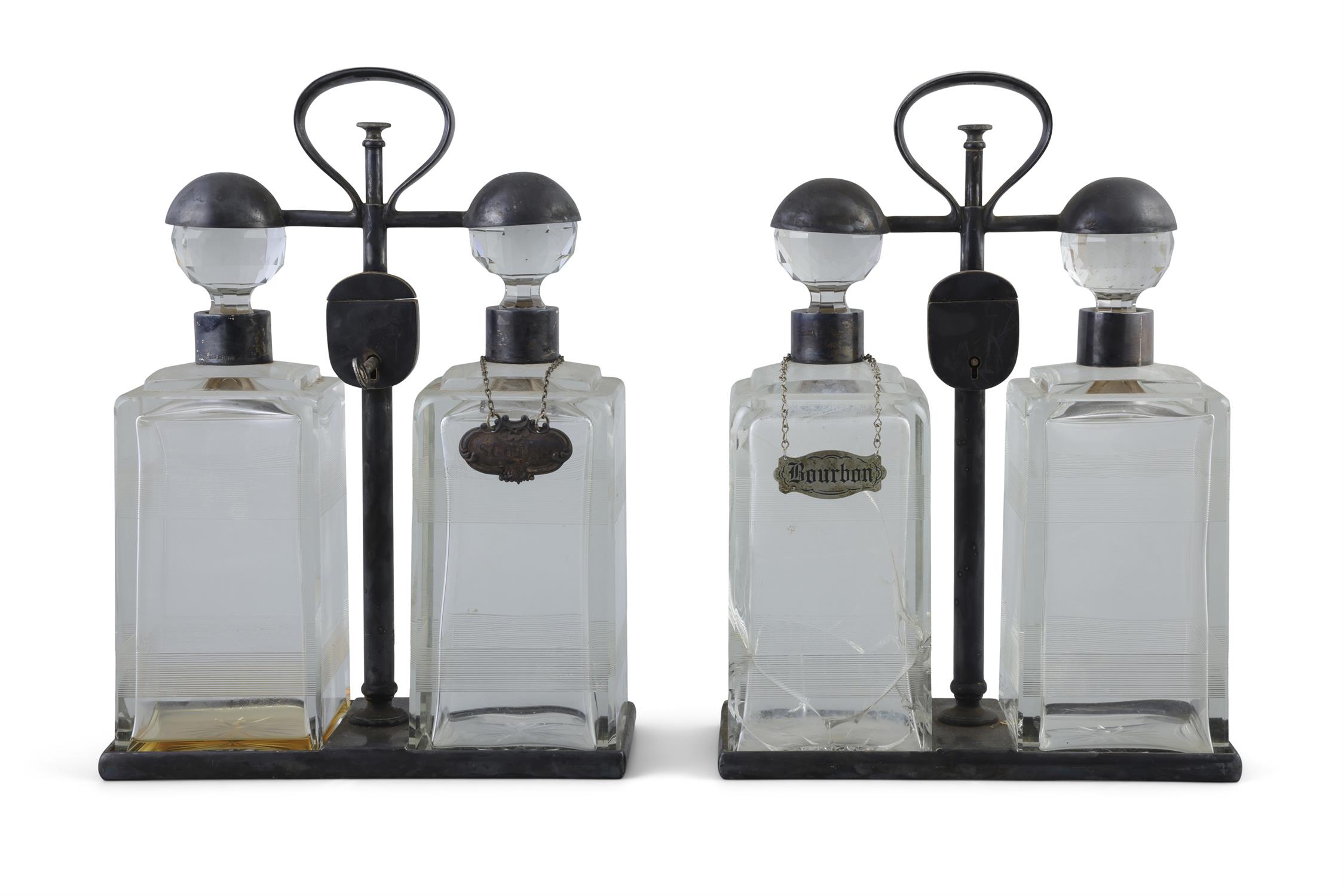 A PAIR OF SPIN TOP DOUBLE DECANTER TANTALUS BY HUKIN & HEATH each carrying frame with locking