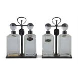 A PAIR OF SPIN TOP DOUBLE DECANTER TANTALUS BY HUKIN & HEATH each carrying frame with locking