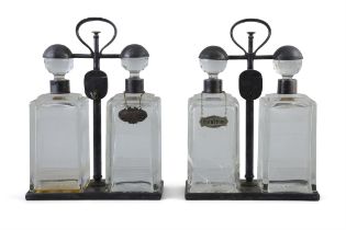 A PAIR OF SPIN TOP DOUBLE DECANTER TANTALUS BY HUKIN & HEATH each carrying frame with locking