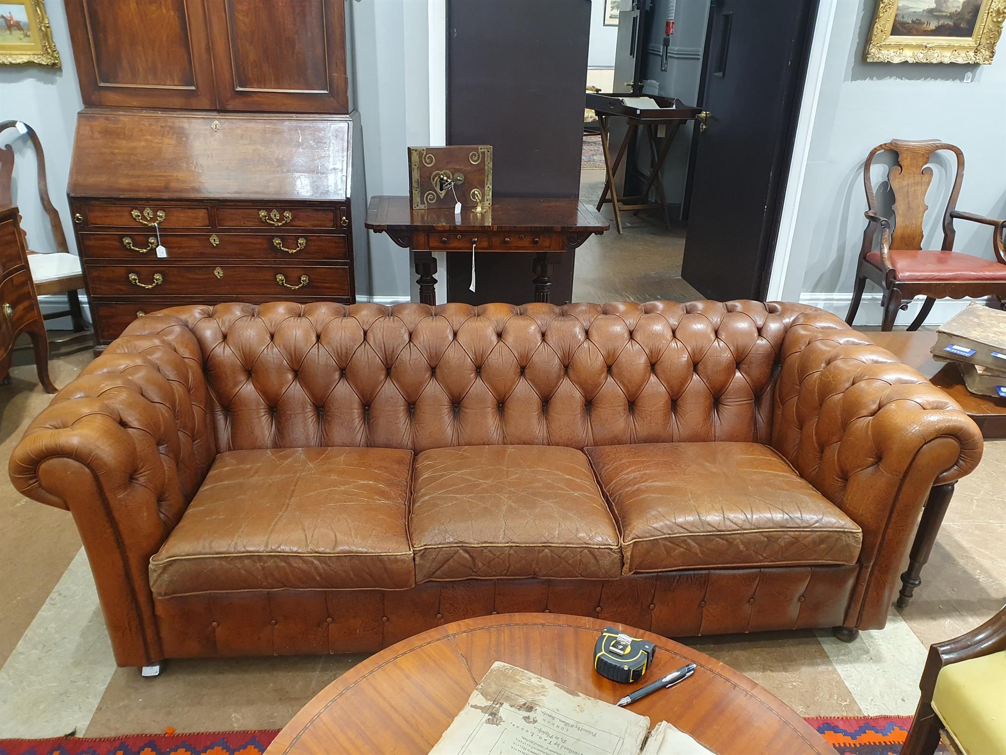 A CHESTERFIELD BUTTON BACK THREE SEATER SOFA, upholstered in brown leather with scroll-end - Image 6 of 18